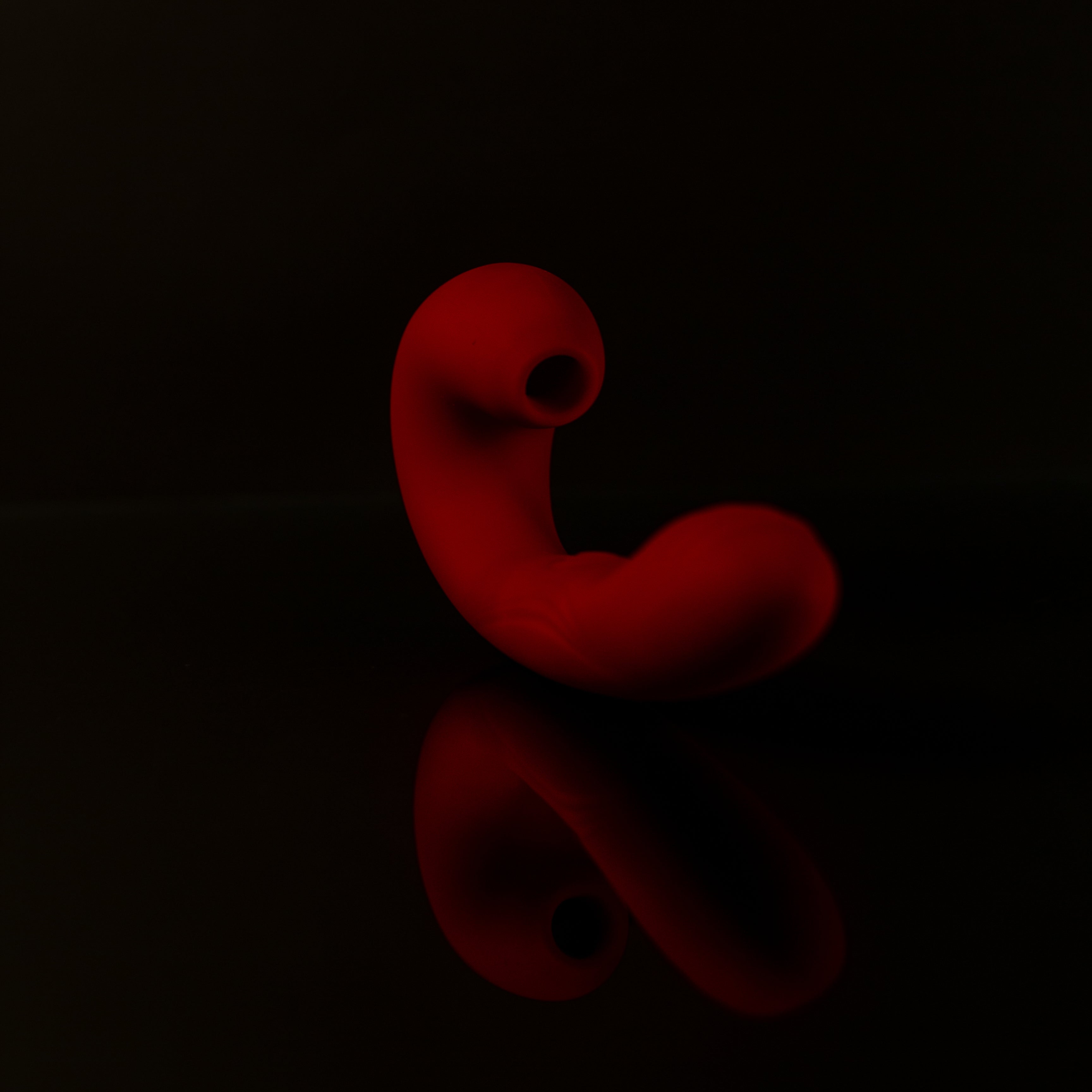 Red pleasure toy on a black background