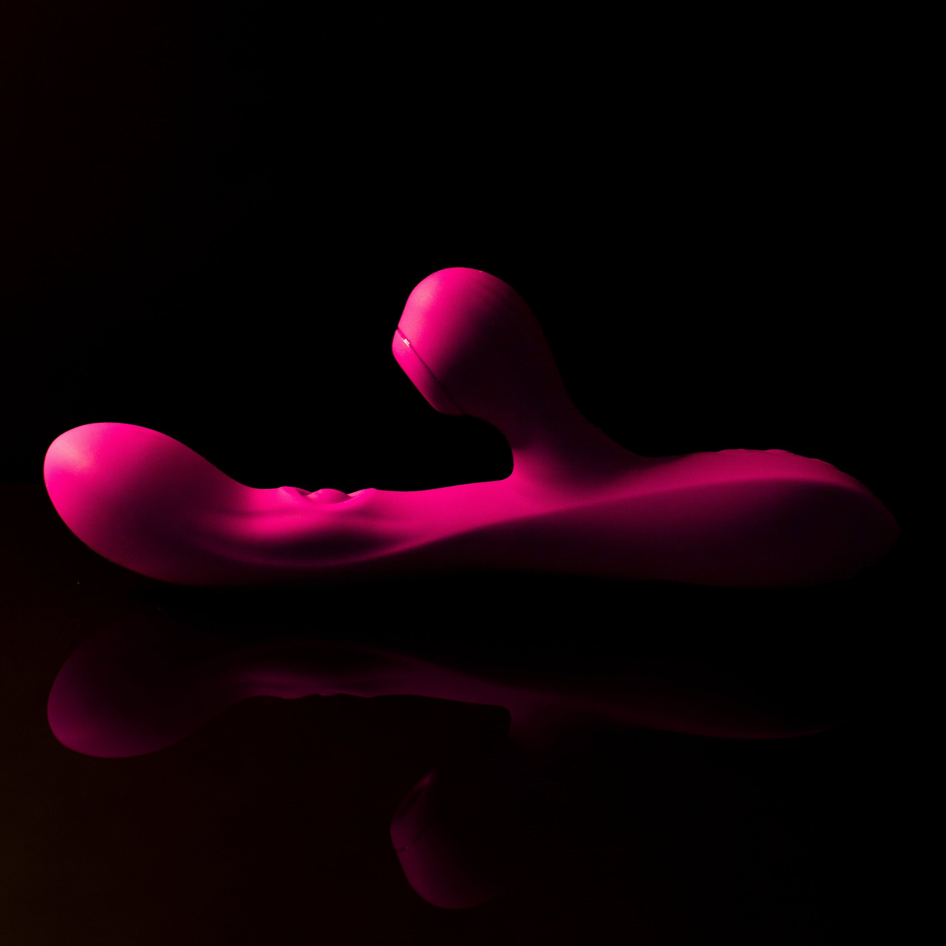 Pink pleasure toy and refelection on a black background
