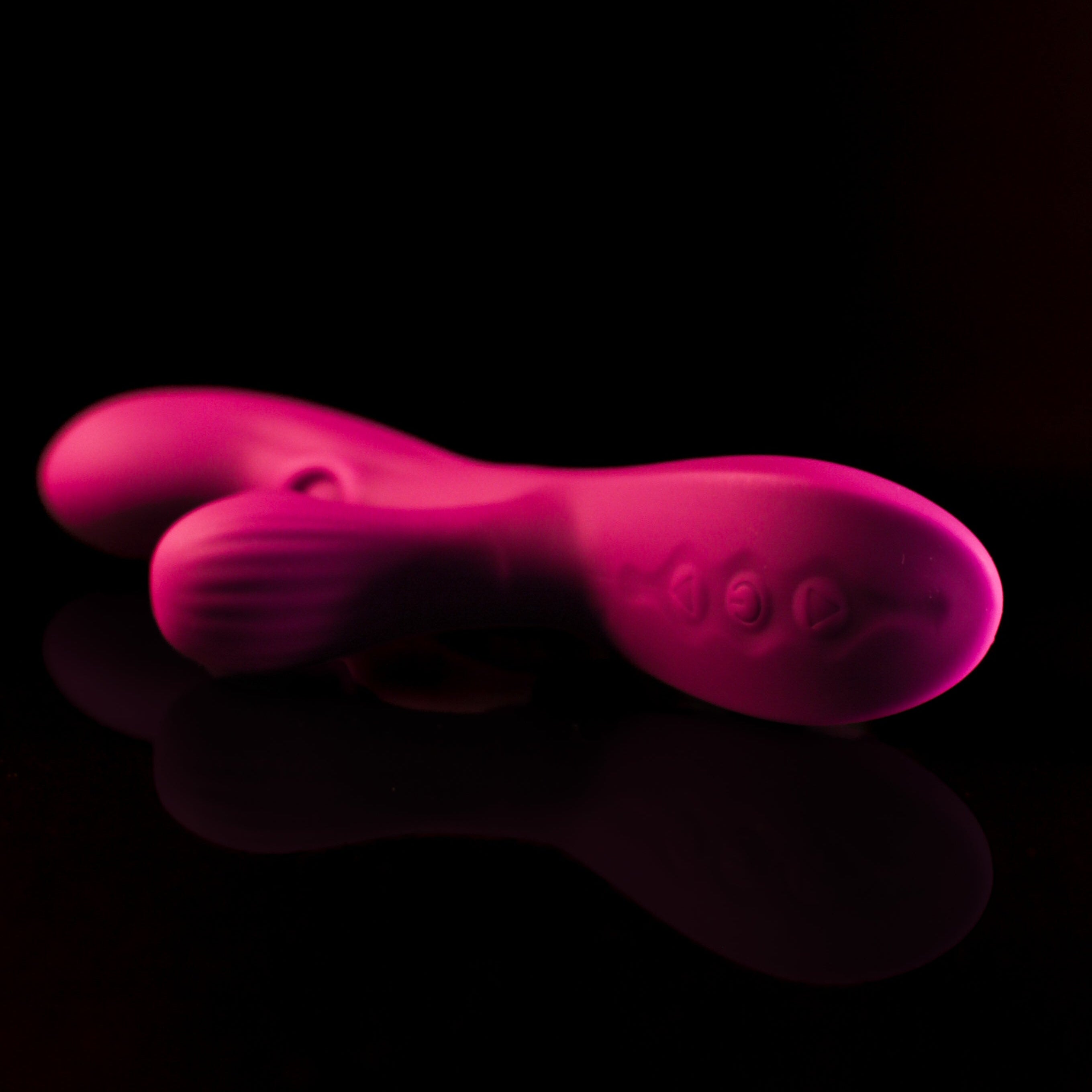 Pink vibration toy on a black background