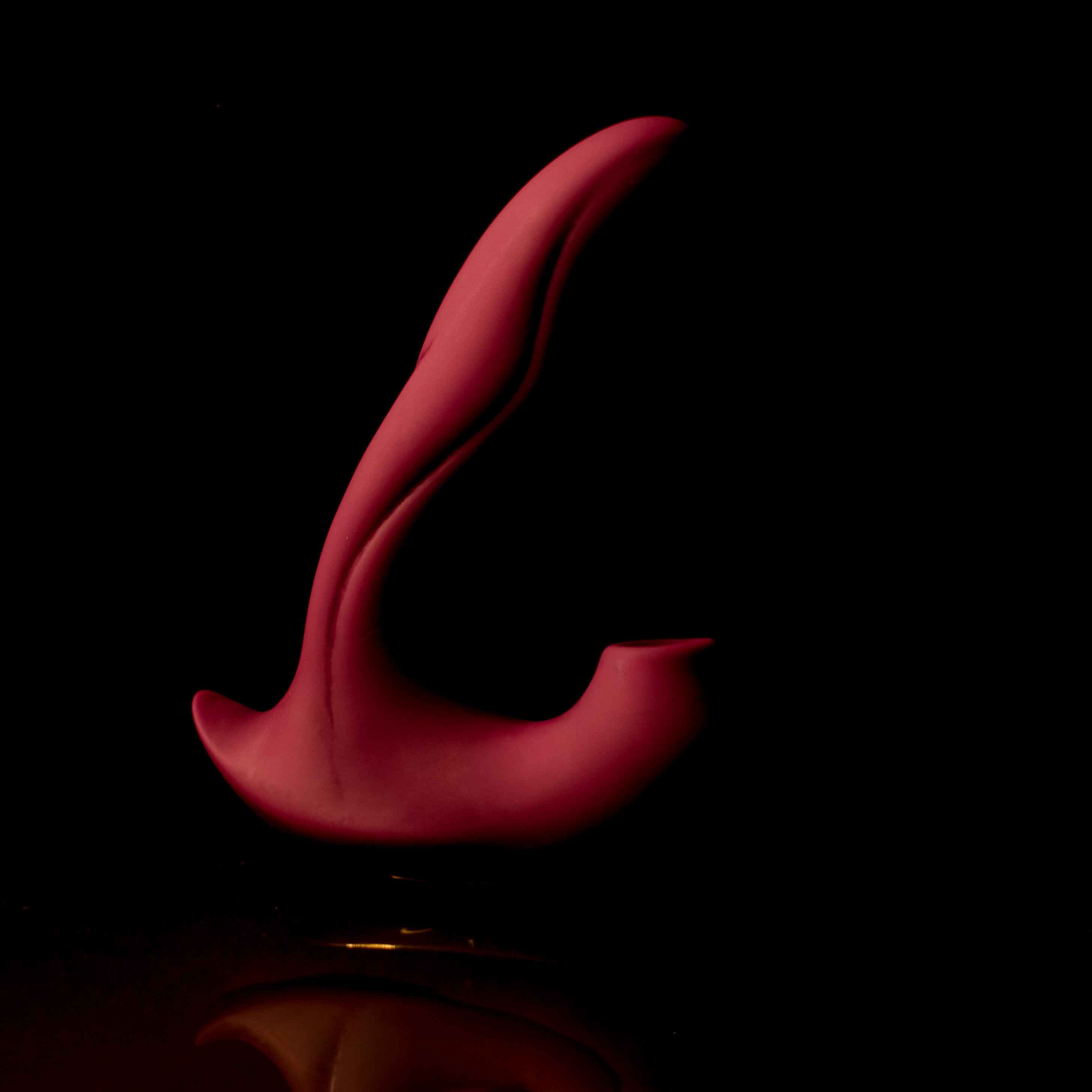 Red pleasure toy on a black background
